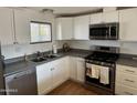 Modern kitchen with stainless steel appliances and white cabinetry at 4065 E University Dr # 300, Mesa, AZ 85205