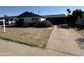 Ranch style home with green trim, single car garage and driveway at 3023 W Larkspur Dr, Phoenix, AZ 85029