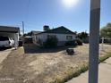 Ranch style home with green trim, single car garage and driveway at 3023 W Larkspur Dr, Phoenix, AZ 85029