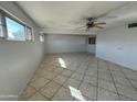 Spacious living room with tile floors and ceiling fan at 3023 W Larkspur Dr, Phoenix, AZ 85029