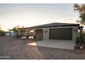 Single story home with covered patio, garage, and desert landscaping at 43630 N 20Th St, New River, AZ 85087