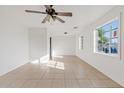 Spacious living area with tile floors and ceiling fan at 724 S Lewis Rd, Mesa, AZ 85210