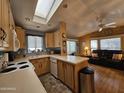 Open kitchen with island and view into living room at 8700 E University Dr # 1931, Mesa, AZ 85207