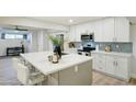 Modern kitchen with white cabinets, quartz countertops, and a large island at 6124 N 12Th Pl # 5, Phoenix, AZ 85014