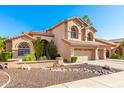 Two-story house with three-car garage and desert landscaping at 1367 E Desert Flower Ln, Phoenix, AZ 85048
