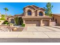 Two-story house with three-car garage and desert landscaping at 1367 E Desert Flower Ln, Phoenix, AZ 85048