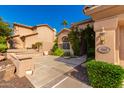 Front entry with stone pathway, mature shrubs, and a light fixture at 1367 E Desert Flower Ln, Phoenix, AZ 85048