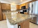 Island kitchen with granite countertops and stainless steel appliances at 1773 E Cardinal Dr, Casa Grande, AZ 85122