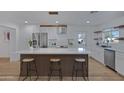 Modern kitchen island with white quartz countertop and wooden accents at 6925 E Almeria Rd, Scottsdale, AZ 85257