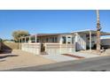 Mobile home with covered porch and small yard at 17200 W Bell Rd # 450, Surprise, AZ 85374