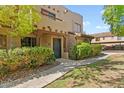 Spanish-style condo building with walkway and landscaping at 1446 E Grovers Ave # 26, Phoenix, AZ 85022