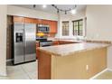 Kitchen with stainless steel appliances and wood cabinets at 1446 E Grovers Ave # 26, Phoenix, AZ 85022
