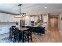 Modern kitchen with island, stainless steel appliances, and breakfast bar at 17663 W Straight Arrow Ln, Surprise, AZ 85387