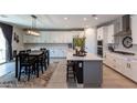 Modern kitchen with island, stainless steel appliances, and breakfast bar at 17663 W Straight Arrow Ln, Surprise, AZ 85387
