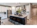 Modern kitchen with island, stainless steel appliances, and breakfast bar at 17663 W Straight Arrow Ln, Surprise, AZ 85387