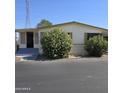 Tan mobile home exterior with landscaping at 11596 W Sierra Dawn Blvd # 28, Surprise, AZ 85378
