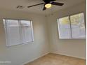 Bright bedroom with two windows and tile floors at 4502 W Crittenden Ln, Phoenix, AZ 85031