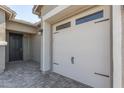 Two-car garage with white door and black hardware at 22207 N Daniel Dr, Maricopa, AZ 85138