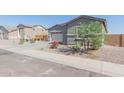 House exterior with gray siding and paver driveway at 22207 N Daniel Dr, Maricopa, AZ 85138