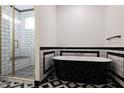 Modern bathroom with a free-standing tub and walk-in shower at 31214 N 167Th Ave, Surprise, AZ 85387