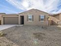 Newly built home with neutral exterior, two-car garage, and desert landscaping at 8639 W Albeniz Pl, Tolleson, AZ 85353