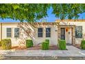 Ranch style home with well-manicured landscaping and brick accents at 10038 W Hawthorn Dr, Sun City, AZ 85351