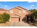 Two-story house with a large garage and landscaping at 1542 E Chaparral Pl, Casa Grande, AZ 85122