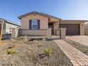 House exterior showcasing a brick walkway, stone accents, and a well-maintained front yard at 4693 N 177Th Ln, Goodyear, AZ 85395