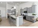 Modern kitchen with gray cabinets, white countertops, and a large island at 331 W Dundy St, San Tan Valley, AZ 85143