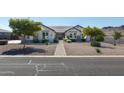 Single story home with brick accents and a well manicured lawn at 331 W Dundy St, San Tan Valley, AZ 85143