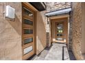 Front entry with modern doors and stone accents at 16076 E Ridgestone Dr, Fountain Hills, AZ 85268
