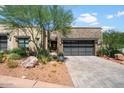 Modern home exterior with stone and paver driveway at 16076 E Ridgestone Dr, Fountain Hills, AZ 85268