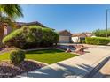 Home exterior with artificial turf and desert landscaping at 13629 W San Miguel Ave, Litchfield Park, AZ 85340