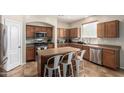 Kitchen with island, stainless steel appliances, and wood cabinets at 16079 W Williams St, Goodyear, AZ 85338