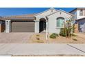 Modern stucco home with a two-car garage and desert landscaping at 14436 W Faye Way, Surprise, AZ 85387