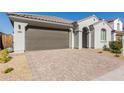 Modern stucco home with a two-car garage and desert landscaping at 14436 W Faye Way, Surprise, AZ 85387