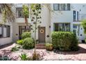 Charming house exterior with a gray door and well-maintained landscaping at 4955 E Indian School Rd # 9, Phoenix, AZ 85018