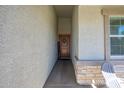 Inviting entryway with wood door and stone accents at 18426 W Faye Way, Surprise, AZ 85387