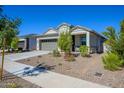 Charming curb appeal with a two-car garage and landscaping at 18426 W Faye Way, Surprise, AZ 85387