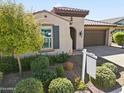 Charming curb appeal with landscaping and a welcoming front porch at 20461 W Briarwood Dr, Buckeye, AZ 85396