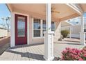 Covered porch with red door and ceiling fan at 7300 N 51St Ave # D212, Glendale, AZ 85301