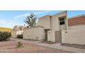 Side view of a two-story stucco home with a gated entry and desert landscaping at 1342 W Emerald Ave # 256, Mesa, AZ 85202