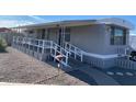 Gray mobile home with covered porch and ramp access at 2460 E Main St # A17, Mesa, AZ 85213