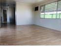 Bright living room with light wood laminate flooring at 2460 E Main St # A17, Mesa, AZ 85213
