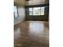 Spacious living room featuring large windows and laminate flooring at 2460 E Main St # A17, Mesa, AZ 85213