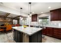 Modern kitchen with granite island and stainless steel appliances at 39839 N Spur Cross Rd, Cave Creek, AZ 85331