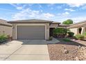 One-story home with gray garage door at 20712 N 273Rd Ave, Buckeye, AZ 85396