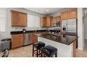 Kitchen with granite countertops and wood cabinets at 20712 N 273Rd Ave, Buckeye, AZ 85396