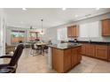 Open kitchen with island and stainless steel appliances at 20712 N 273Rd Ave, Buckeye, AZ 85396