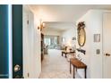 Bright entryway with view into living room, featuring tiled floor and console table at 10960 W Coggins Dr, Sun City, AZ 85351